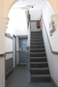 a staircase in an office building with a stair case at Sunnydene in Great Yarmouth