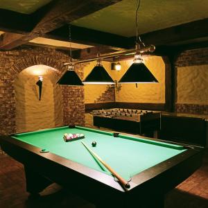 a billiard table in a room with a pool at Hotel Hetman in Kroczyce