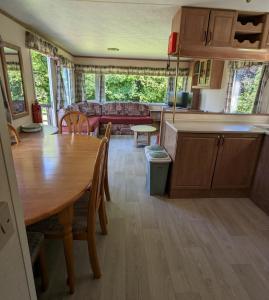 a kitchen and living room with a table and a couch at Glebe Farm Holidays in Newport