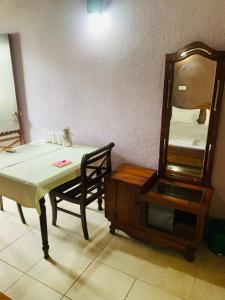 a room with a table and a mirror and a dresser at Hareesha Holiday Resort in Galle