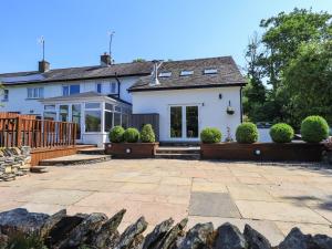 a white house with a patio in front of it at Ellerbeck Bridge in Kendal