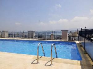 a swimming pool on top of a building at Gran vía in Ribadeo