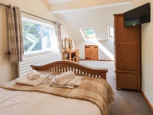 a bedroom with a bed with two towels on it at Ellerbeck Bridge in Kendal