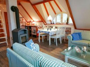 a living room with a table and a fireplace at Ferienhof Kestermann in Neppermin