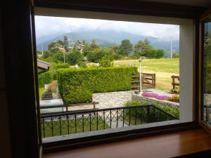 a view of a garden from a window at La Pace della Montagna alle Porte della Città in Aosta