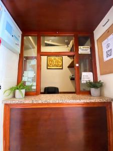 an entrance to an office with two potted plants at Orlando hotel in London