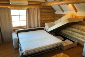 a bedroom with a bed in a log cabin at Kütioru saunamajad in Koloreino