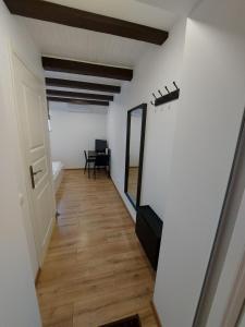 a hallway with a mirror and a chair in a room at B&B Hotel Telsiai in Telšiai