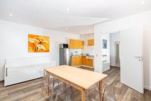 a kitchen and dining room with a table and chairs at Monaco Apartments in Lignano Sabbiadoro