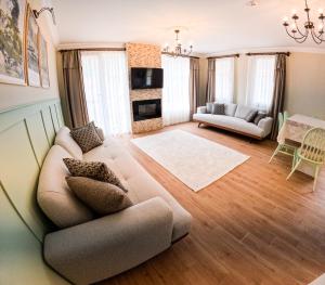 a living room with a couch and a table at Suit Rabando Uzungöl in Uzungöl