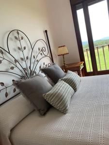 a bedroom with a bed with pillows on it at Villa Juan in La Adrada
