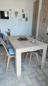 a wooden table and chairs in a living room at Casamare in Torre Forte +5 photos