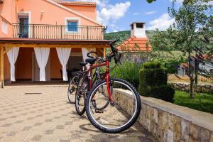 a red bike parked in front of a house at Holiday home Anica in Čavoglave
