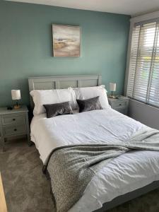 a bedroom with a large white bed with two night stands at Hilltop in Holyhead
