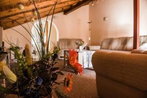 a living room with a couch and a table with flowers at Holiday home Anica in Čavoglave +41 photos
