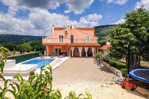 an external view of a house with a swimming pool at Holiday home Anica in Čavoglave