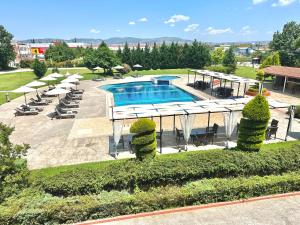 an overhead view of a swimming pool with lounge chairs at Kornilios Palace in Anchialos