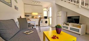 a living room with a couch and a yellow table at Casa del Sol, Costa Calma in Costa Calma