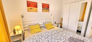 a bedroom with a bed with two yellow pillows at Casa del Sol, Costa Calma in Costa Calma +11 photos