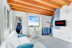 a bedroom with a bed and a desk and a window at [Piscina Panoramica] - La Casa Volante in Soiano del Lago