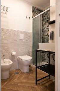 a bathroom with a toilet and a sink at Gravina8 - Rooms in Naples in Naples