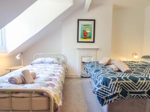 2 camas en una habitación con chimenea en Lodestar, en Deganwy
