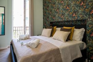 a bedroom with a large bed with towels on it at Gravina8 - Rooms in Naples in Naples