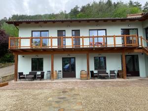 a house with a deck and a patio at Agriturismo Casa del Principe in Torre Bormida