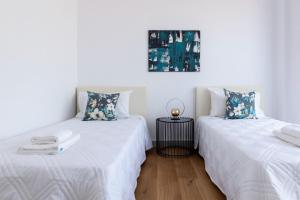 two beds sitting next to each other in a room at Premier 401 3 bedroom penthouse in Paphos City