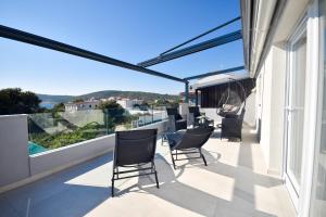 a balcony with chairs and a view of the ocean at Relax House Kanica in Zaglavice