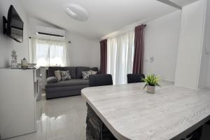 a kitchen and living room with a table and a couch at Relax House Kanica in Zaglavice