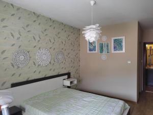 a bedroom with a bed and a wall at Apartment Ventuno 21 in Sliven