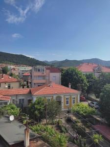 a view of a city with a yellow house at Apartment Ventuno 21 in Sliven