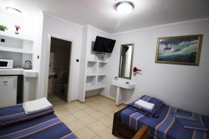 a hotel room with two beds and a television at Sunset Inn in Eilat +37 photos