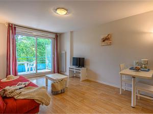 ein Wohnzimmer mit einem Bett, einem Tisch und einem Fenster in der Unterkunft Vacancéole - Ker Goh Lenn - Vannes / Morbihan in Plescop