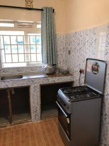 a kitchen with a stove and a counter top at Ludali homes in Kakamega
