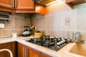 a kitchen with a stove and a sink at Уютная квартирка в центре Тбилиси! in Tbilisi City