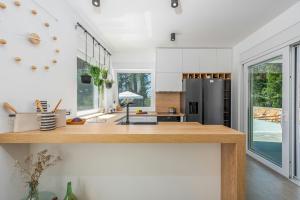 a kitchen with white walls and a wooden counter top at Villa Molaris in Donje Selo