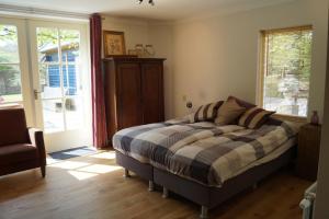 a bedroom with a bed and a sliding glass door at Eersel's Groen in Eersel