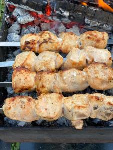 a bunch of food cooking on a grill at Bombora in Mestia