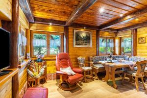 a living room with wooden walls and a wooden ceiling at Blockhaus Günther und Brigitte Serr in Lauf