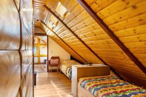 a bedroom with a bed in a wooden attic at Blockhaus Günther und Brigitte Serr in Lauf