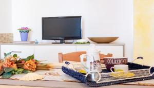 A television and/or entertainment centre at Luxury Apartments - Torre San Giovanni