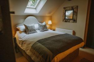 a bedroom with a large bed with a window at Vicarage Farm Cottages in Tideswell