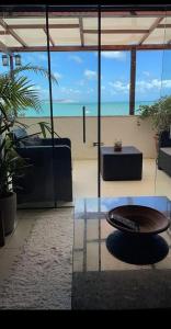 a living room with a view of the ocean at Coco Beach in Natal