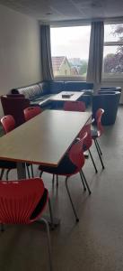 a group of tables and chairs in a room at Solborg Folkehøgskole Hostel in Stavanger