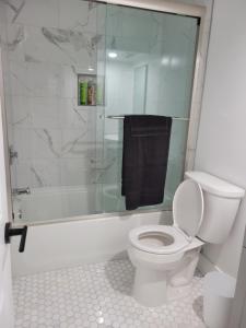 a bathroom with a toilet and a glass shower at The Kickback! in Washington, D.C.