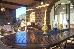 a wooden table with two pineapple vases on top of it at iFlat Dammusi Thienzo in Pantelleria