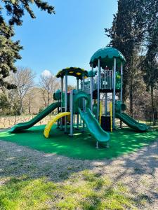 a playground with a slide in a park at Le Chalet de Louise 7 places in Taradeau
