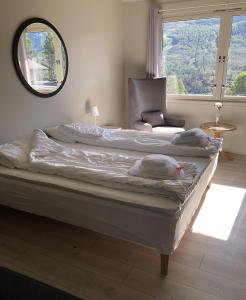 two beds in a room with a large window at Hallingskarvet Fjellstue as in Hovet